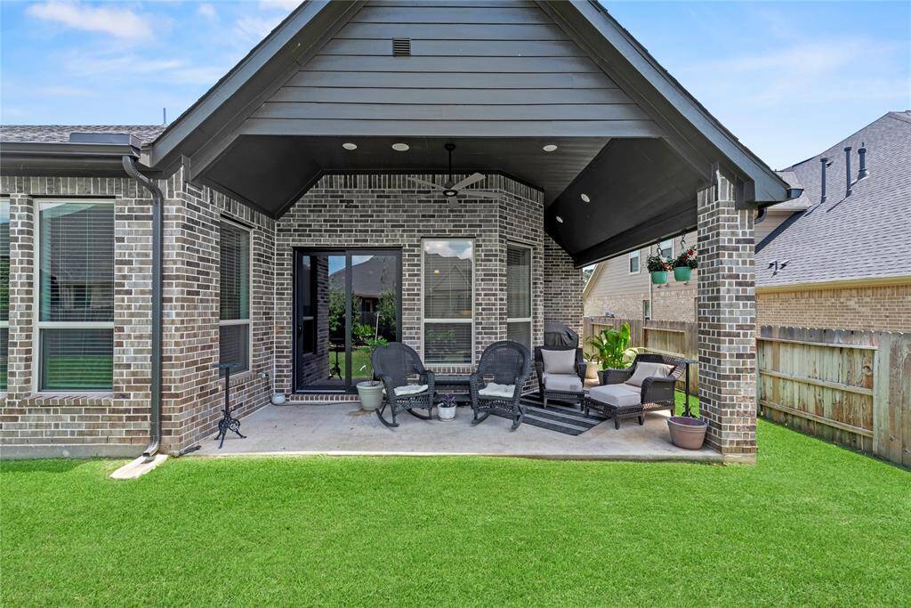 The extended covered patio offers the perfect spot to relax and unwind, providing a tranquil setting to watch the sunset in comfort and style.
