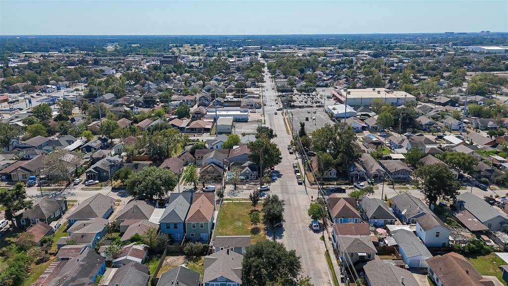 An aerial view shows a 5000 sqft lot with convenient access to Hwy 90. This property is ready for your improvements.