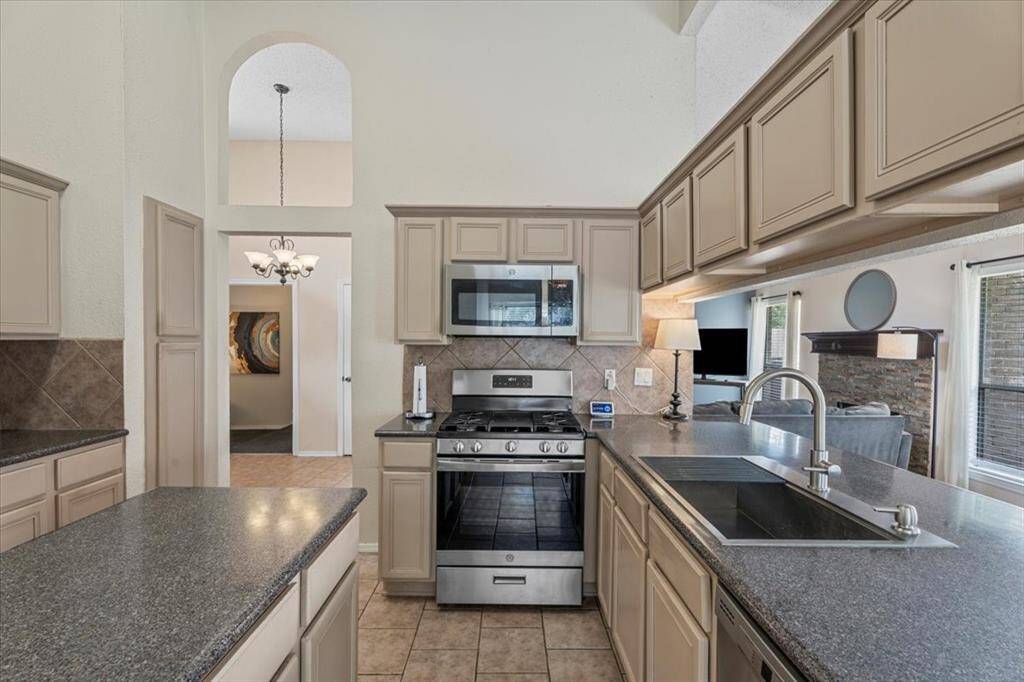 The kitchen offers a central island and farmhouse sink, combining style and functionality—ideal for food prep, entertaining, and holiday gatherings.