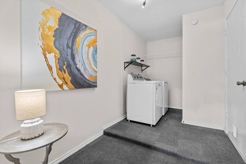 Step into the oversized laundry room, which offers ample space and leads directly into the converted garage area for added functionality.