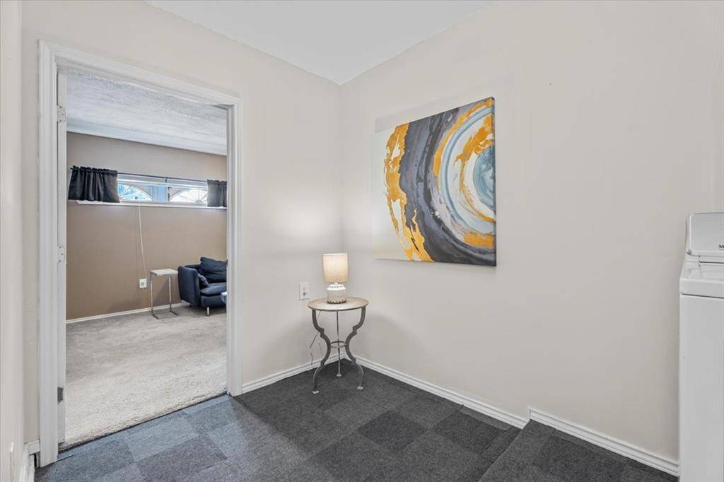 Step into the oversized laundry room, which offers ample space and leads directly into the converted garage area for added functionality.
