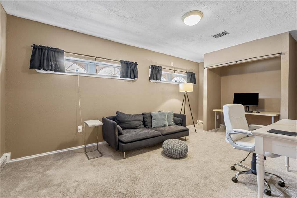 Formerly a two-car garage, this climate-controlled space offers endless possibilities—perfect as an additional bedroom, a home office, or a comfortable area for family and guests.