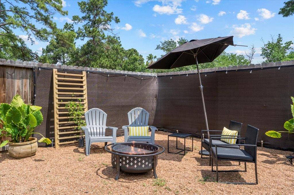 Enjoy your own outdoor retreat with a fully fenced yard, featuring a fire pit and space to gather with friends and family.