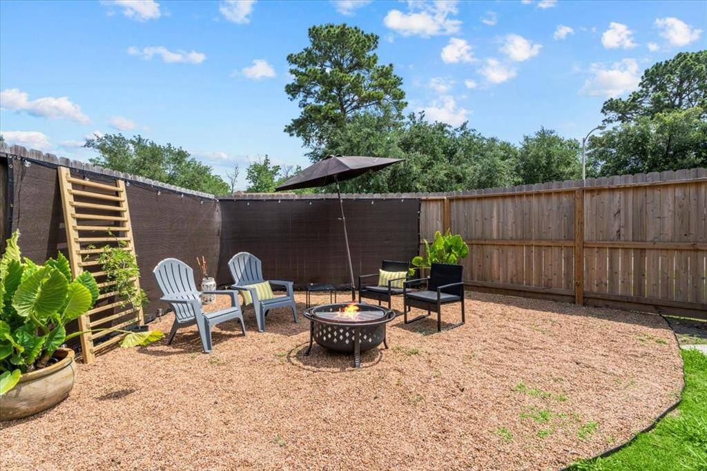 Enjoy your own outdoor retreat with a fully fenced yard, featuring a fire pit and space to gather with friends and family.