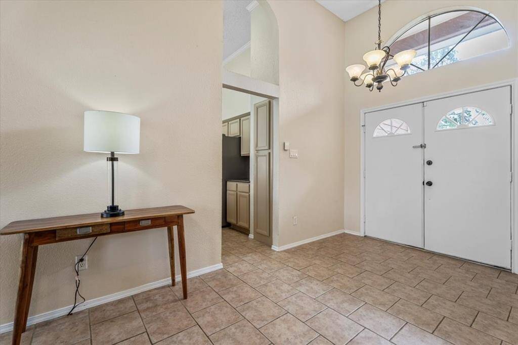 Step into a spacious foyer that offers the perfect first impression—warm, stylish, and inviting.