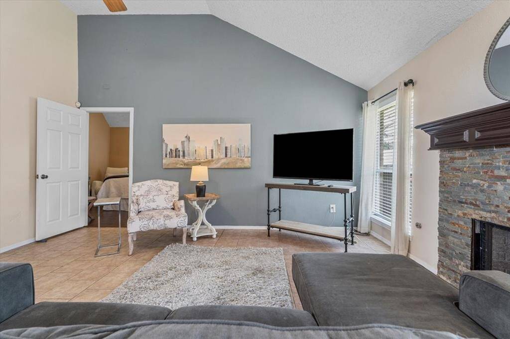 Enjoy the spacious feel of high ceilings and sunlit interiors in this bright and open living room.