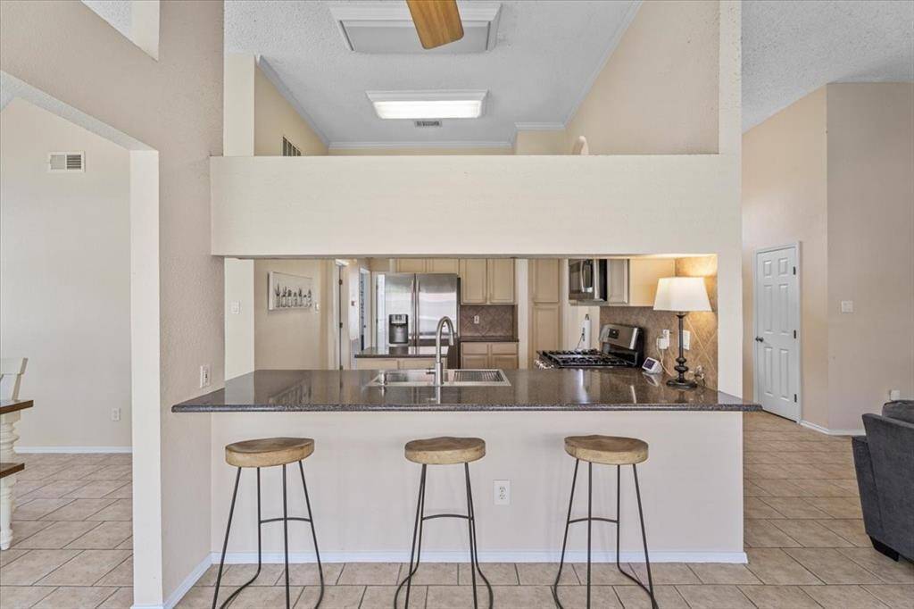 The kitchen features a convenient breakfast bar, blending functionality with casual dining space.