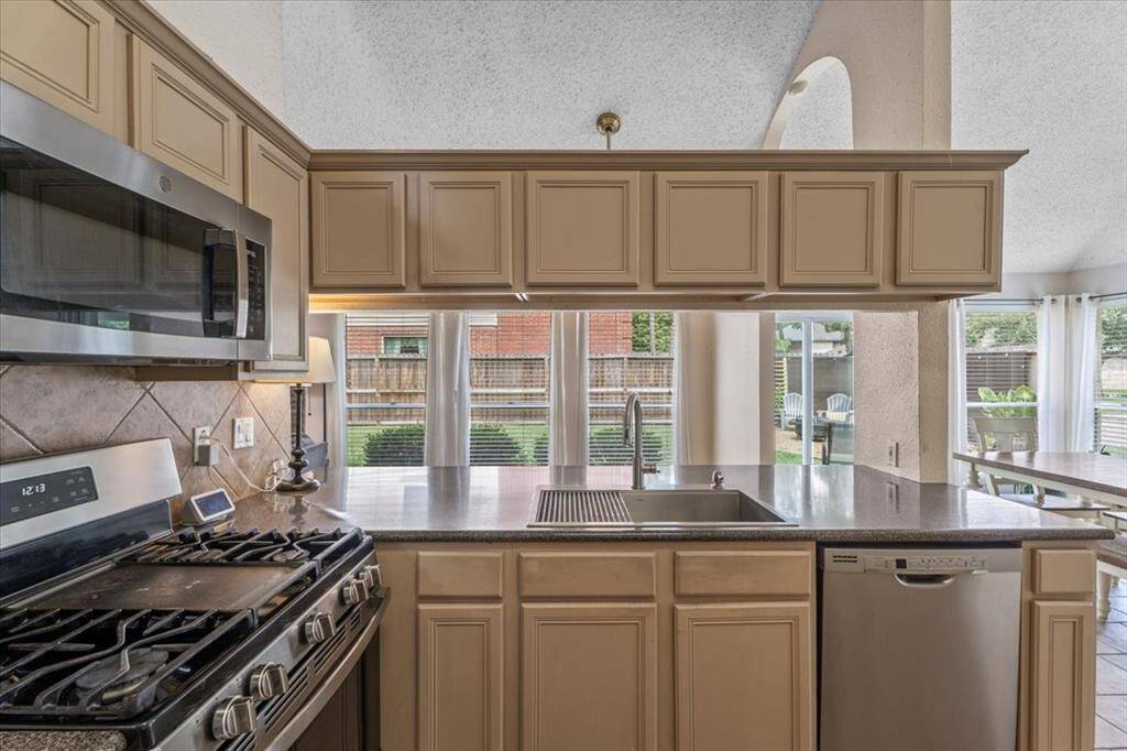 Highlighted by stainless steel appliances and a gas cooktop, this kitchen offers both style and performance.