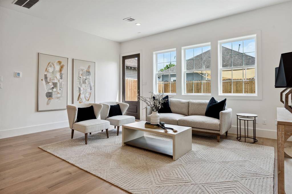 Soaked in natural light, the living room offers a cozy retreat with clean lines and a welcoming enviroment.