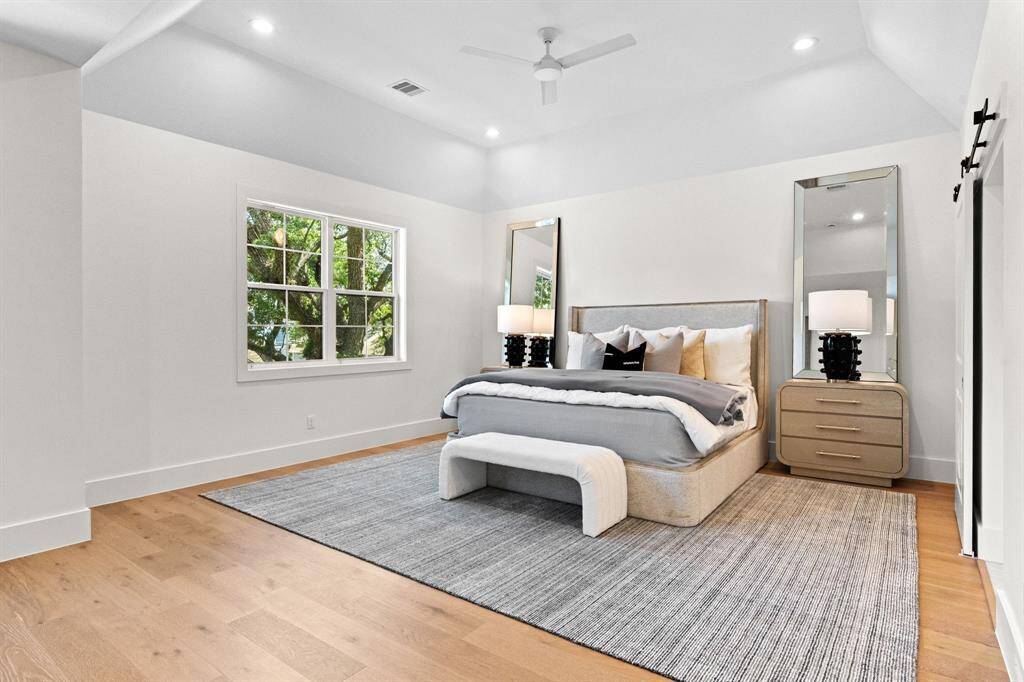 A serene retreat with vaulted ceilings and oversized windows, creating a peaceful escape from the day.
