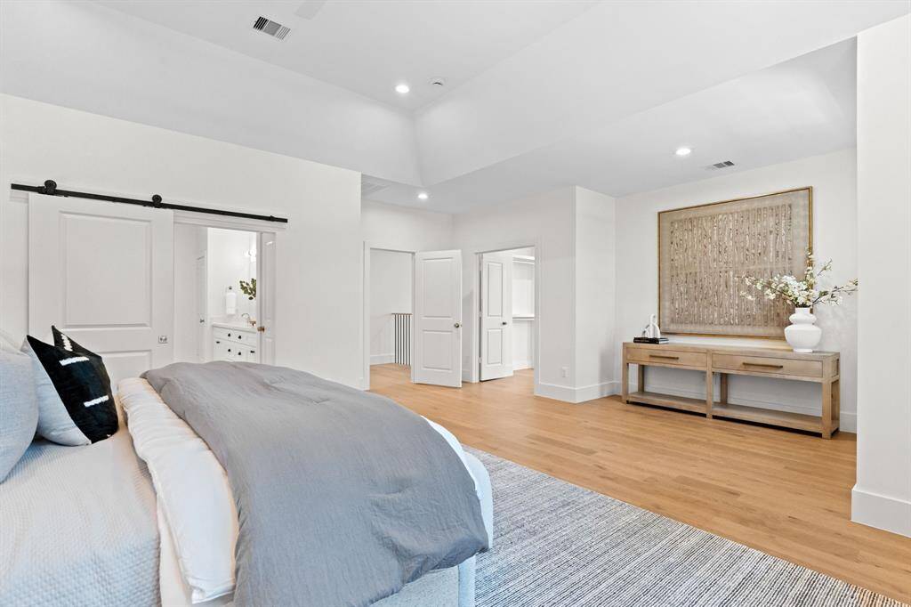 The primary suite offers generous space with seamless flow into the en suite bath and walk-in closet.