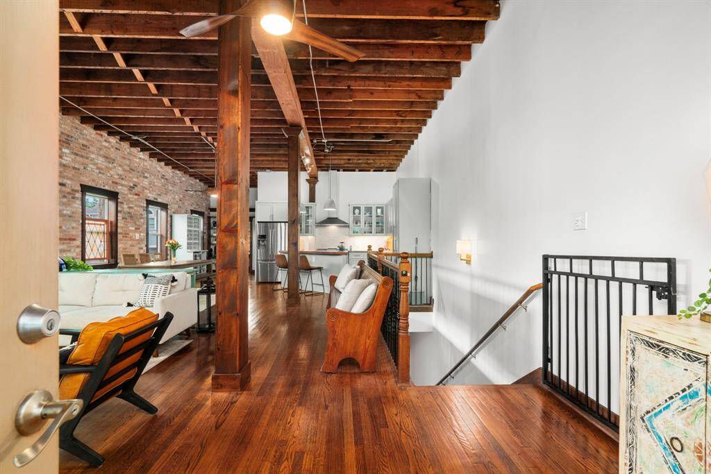 Enjoy soaring 12’ ceilings, exposed beams, original stained glass, and a preserved church pew from the 1940s.