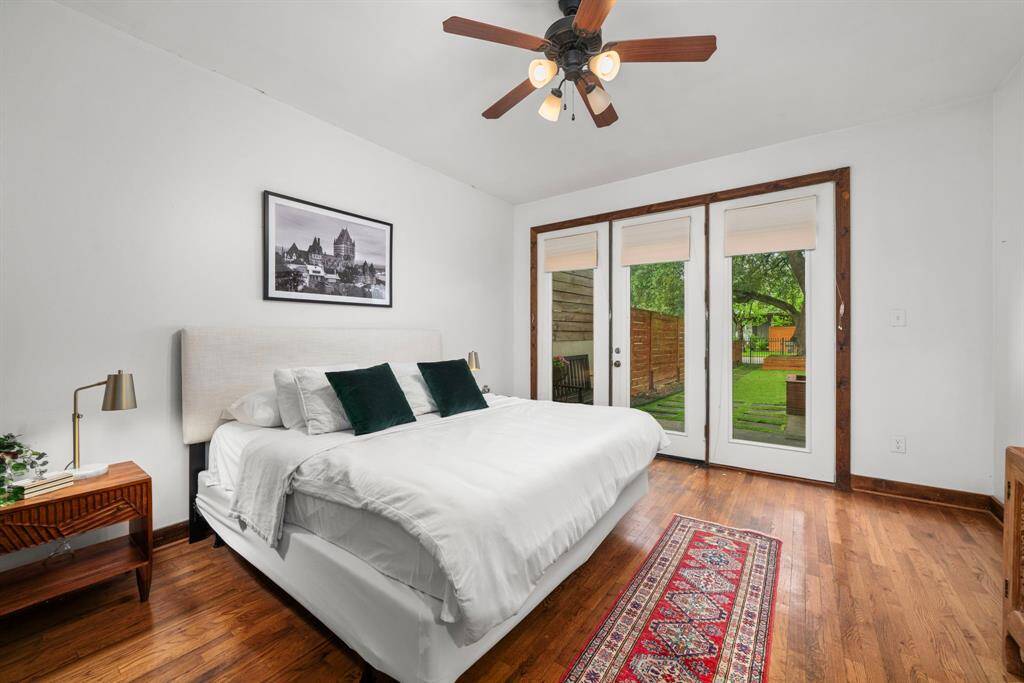 Primary bedroom features french doors that lead out to the yard.