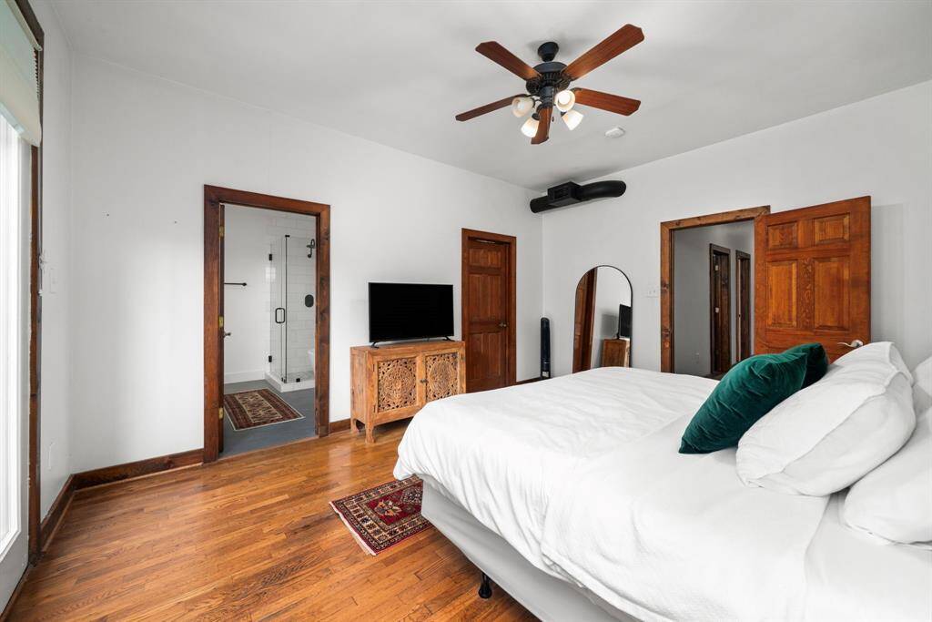Primary bedroom features french doors that lead out to the yard.