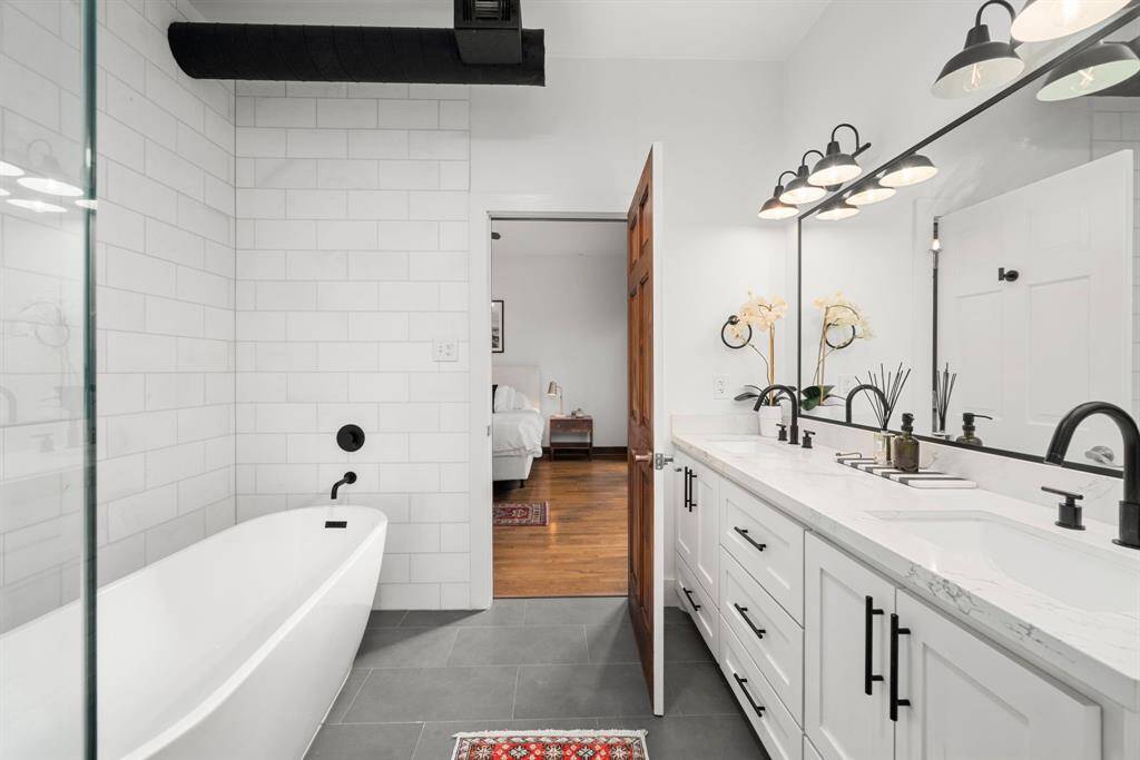 The remodeled primary suite offers 2 walk-in closets and an elegant en-suite bath.