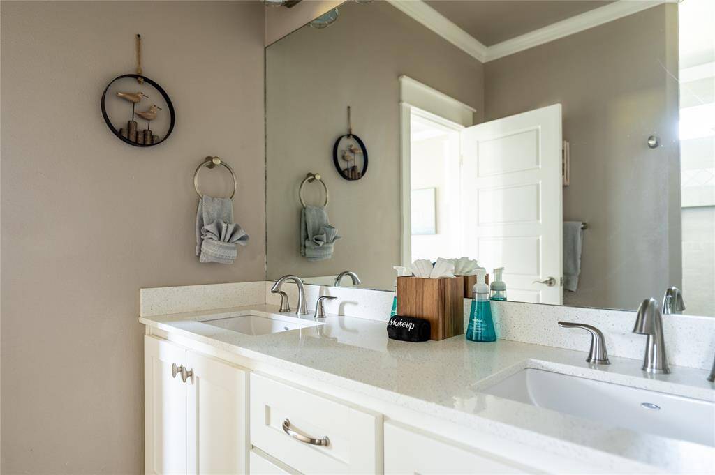 The primary bathroom features double sinks, a walk in shower and lots of storage!