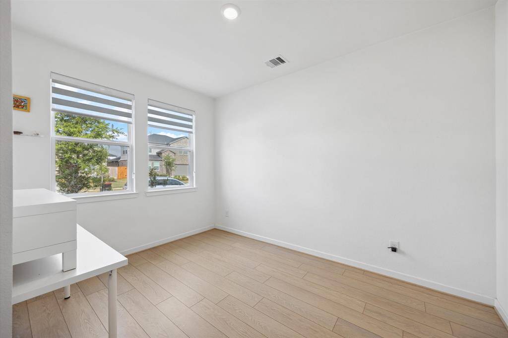 Study/flex space by front door. Modern zebra blinds throughout.
