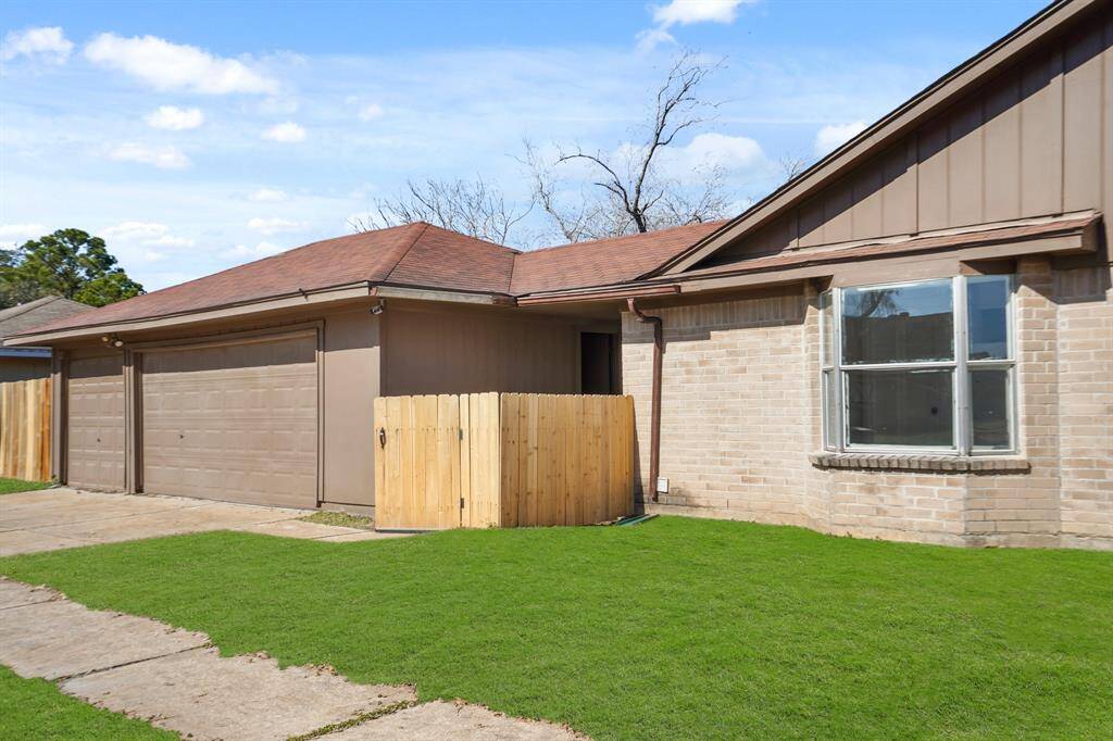 Corner lot view with 3 car garage