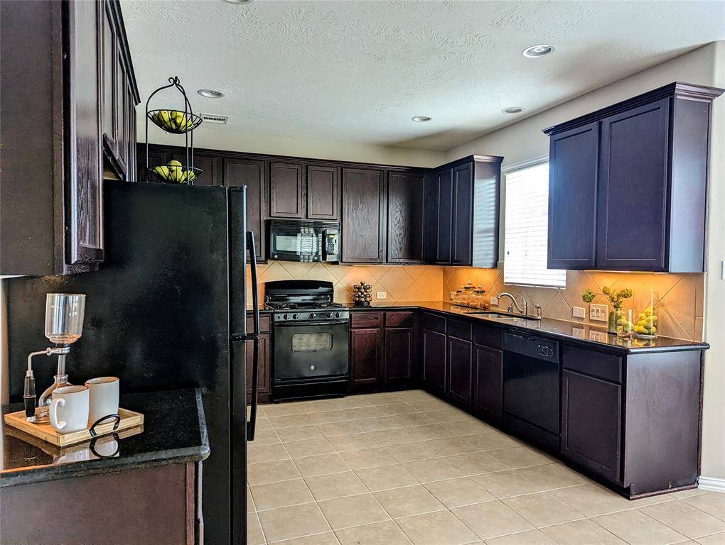 Tall cabinets and granite countertops.