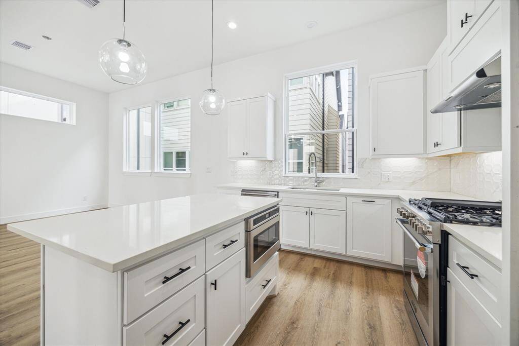 Huge spacious modern open floor plan. Wood and iron spindle rails on your wood staircase. High ceilings and beautiful luxury vinyl flooring.
