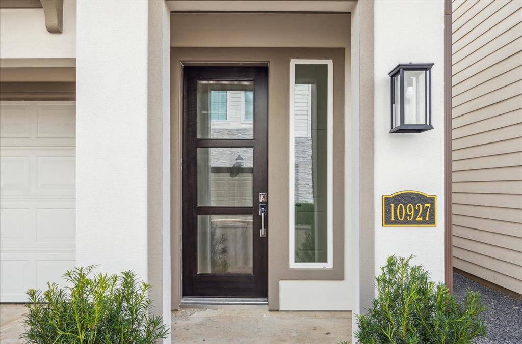 The home has a stunning modern glass door.