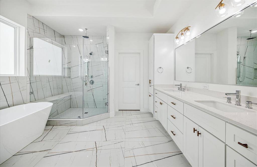 welcome to your spa like bathroom with freestanding soaking tub and a huge glass shower.. Double sinks, designer, tile, and beautiful finishes.