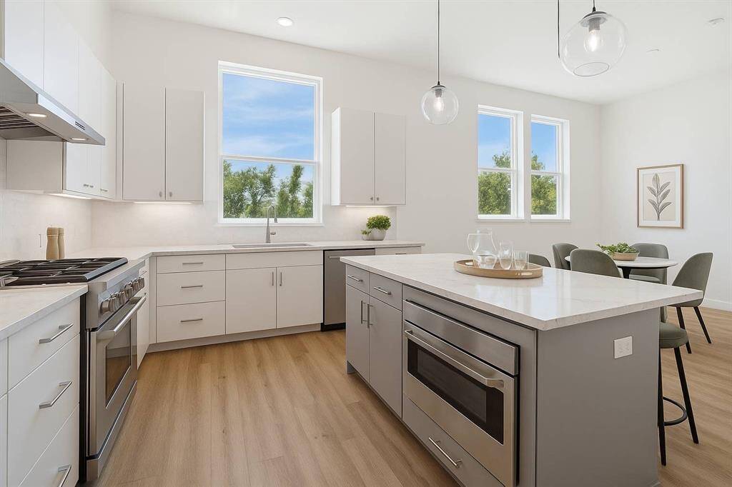 Here’s a view in your kitchen looking back into your dining area. Beautiful upgraded Shaker style soft close cabinets and plenty of windows To bring in lots of light.