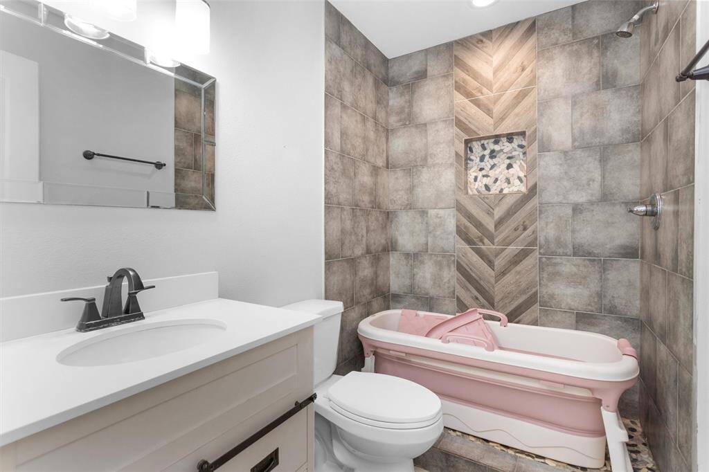 Guest bath with large walk in shower and a portable tub that can come with the home