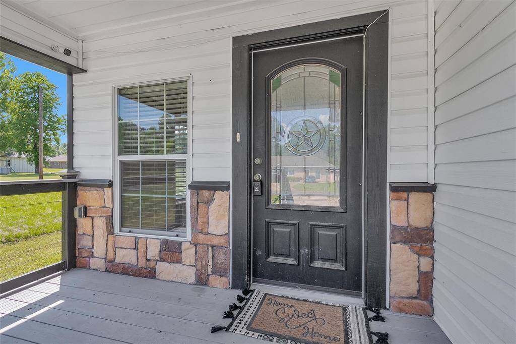 Front entry is inviting and the large covered porch is amazing
