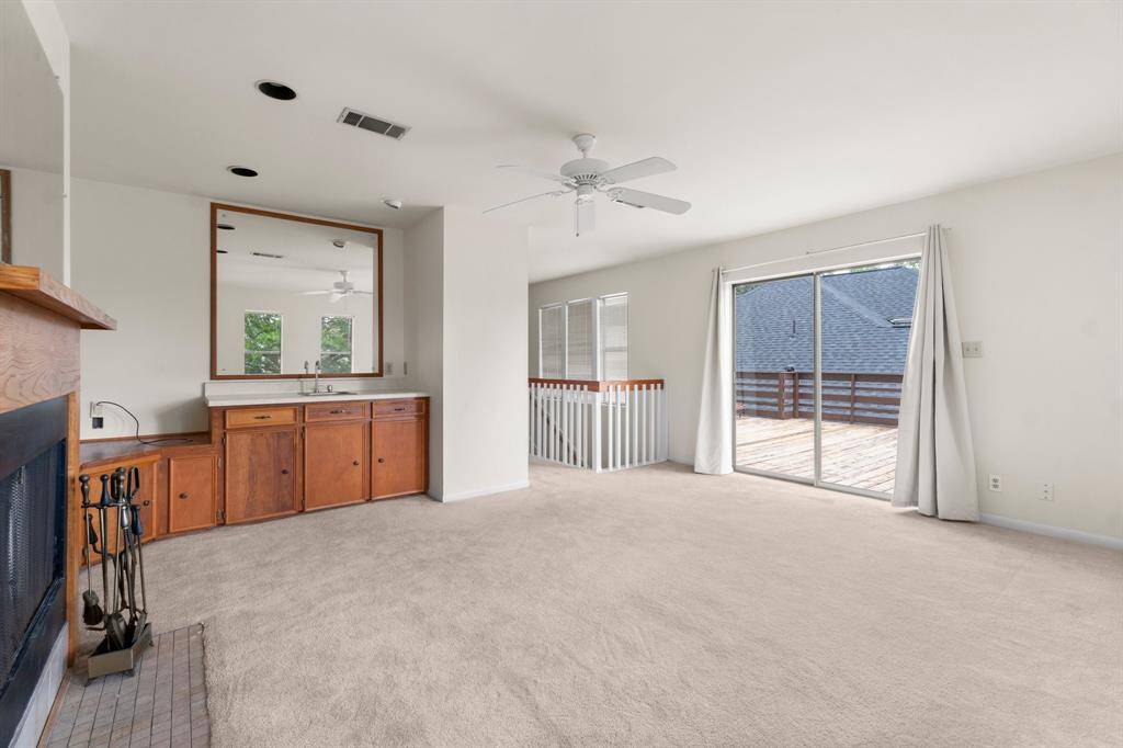 Sliding glass doors allow access to the expansive second-story deck.
