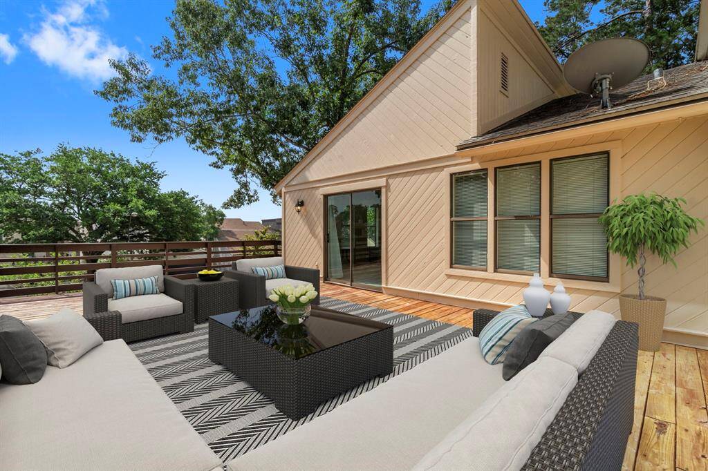 This expansive second-story deck is ideal for entertaining, enjoying morning coffee, or simply unwinding while taking in the serene setting! (Virtually Staged)