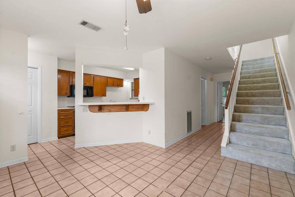 Looking in to the kitchen from the Dining area. Laundry room and half bath are down the hall, to the left. The primary Bedroom is at the end of the hall.