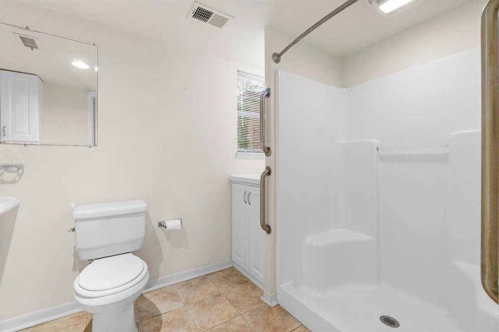 Primary Bathroom features large walk in shower and extra storage.