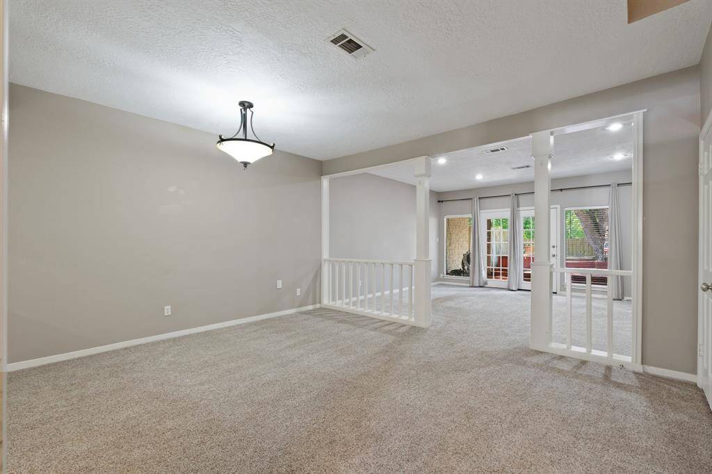 View of dining and living area from staircase.