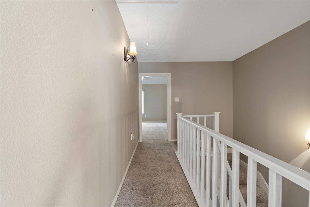 This HALLWAY at the top of the stairs connects the 2 bedrooms