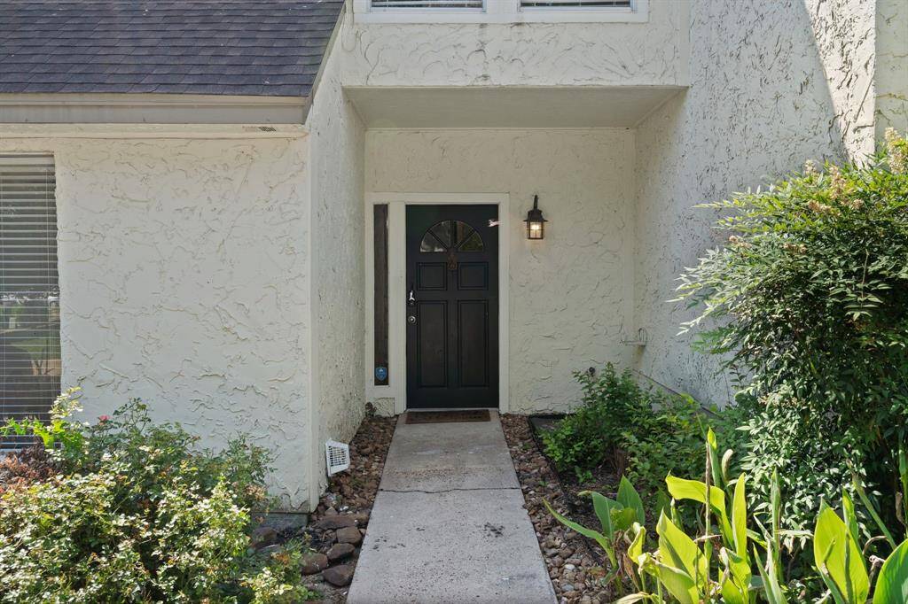 Welcoming front entry with adorning plants and greenery