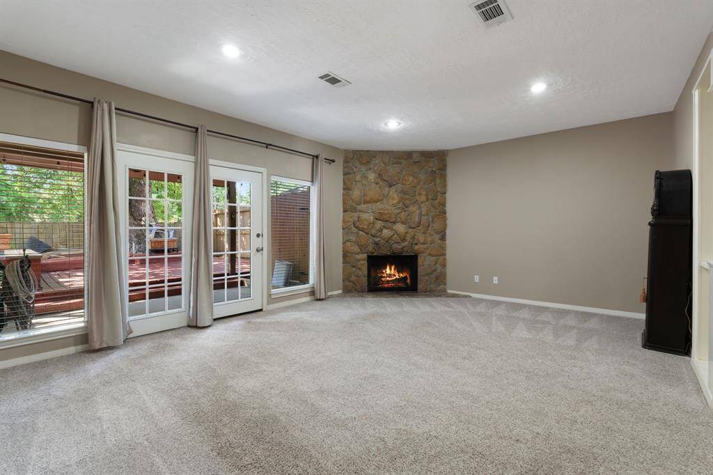Living area with FRENCH DOORS looking at serene back porch view.