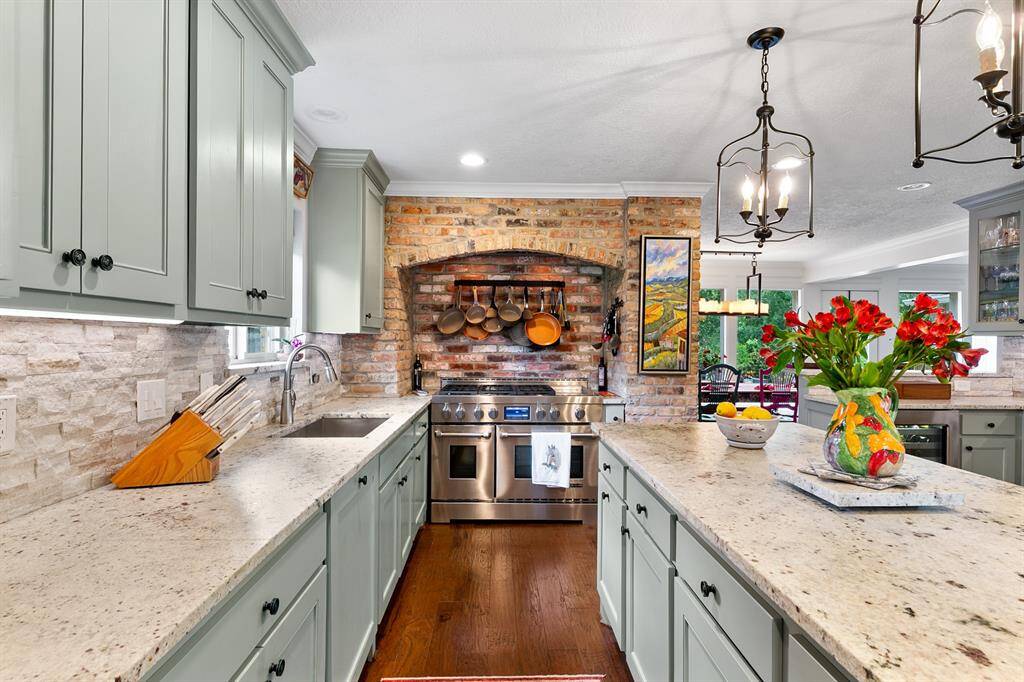 Charming European-inspired elements such as the brick oven enclosure and the open lantern lighting are thoughtfully woven the the home.