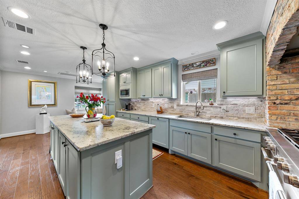 Custom cabinetry with soft close doors integrates the dishwasher, trash drawer and spice rack.