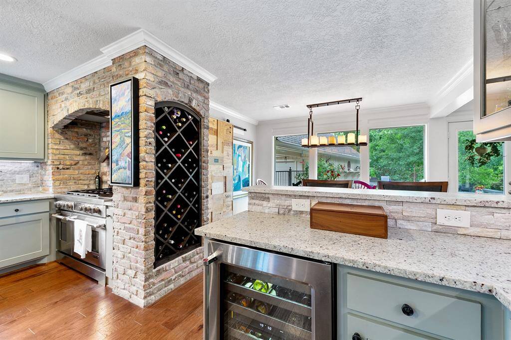 Custom wood wine rack wrapped in the brick casing artfully displays wine bottles.