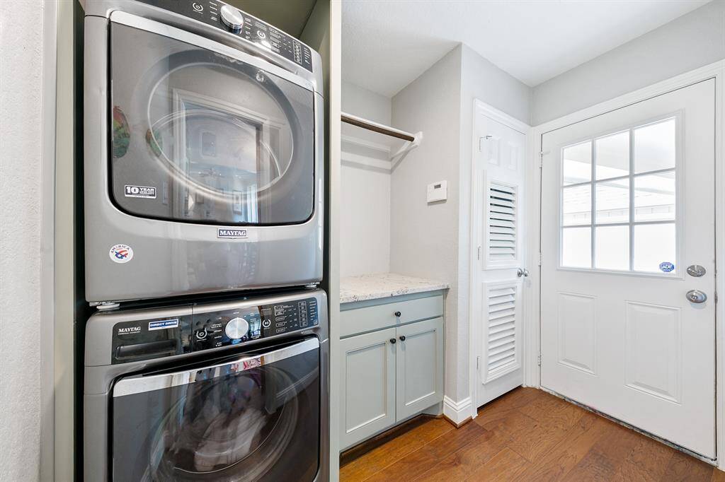When redesigning this home, the laundry room was not forgotten with an extension of the French blue cabinetry and warm hardwoods.