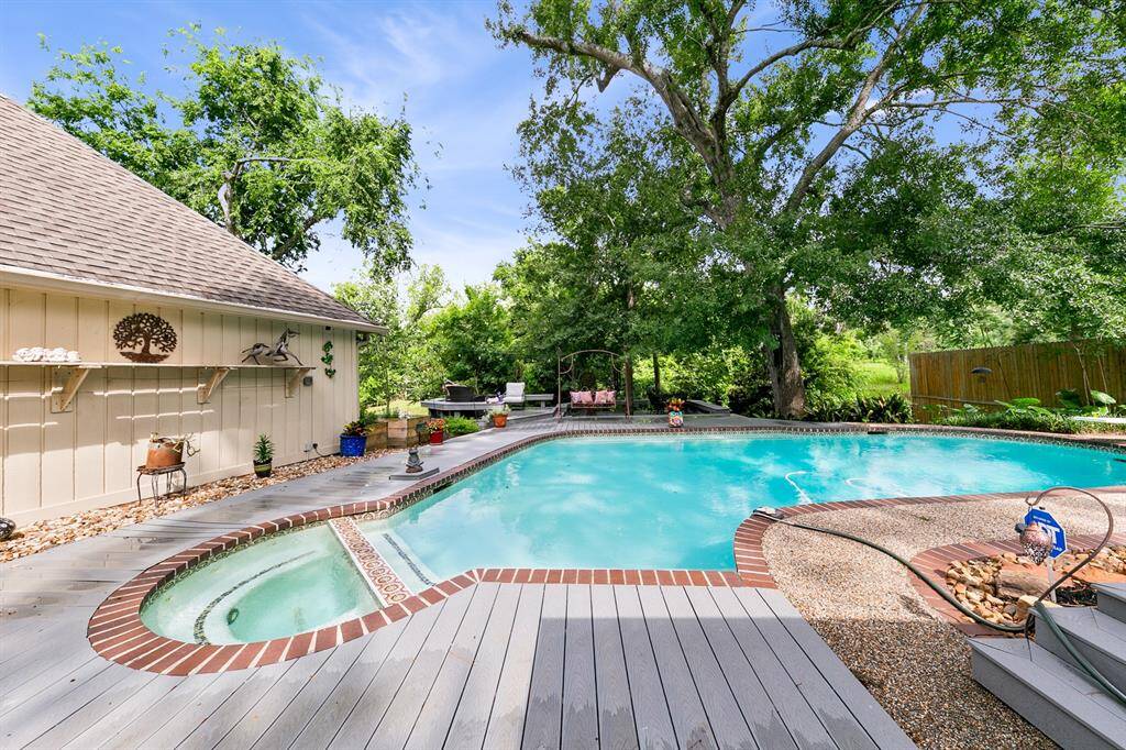 All weather Trex decking surrounding the pool and hot tub.