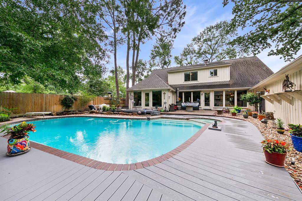 A view of the back of the house shows the bank of windows, the lifetime Trex decking and multiple spots for gardens.