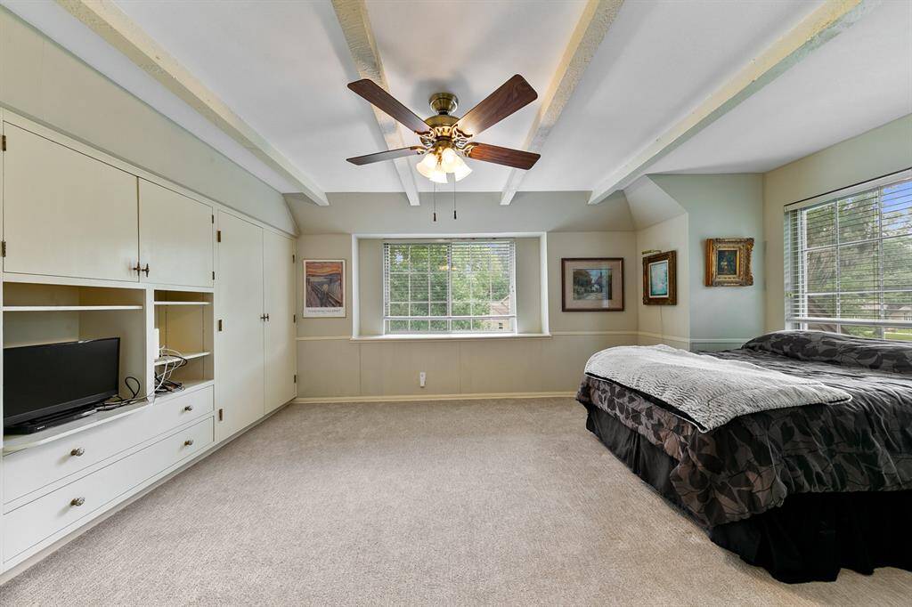 Large guest bedroom with spacious closet and built-in cabinets was primarily used as a game room.