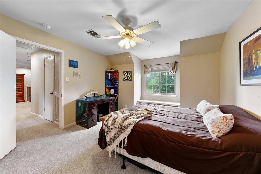 Another view showing the third bedroom and access to the second floor landing area.