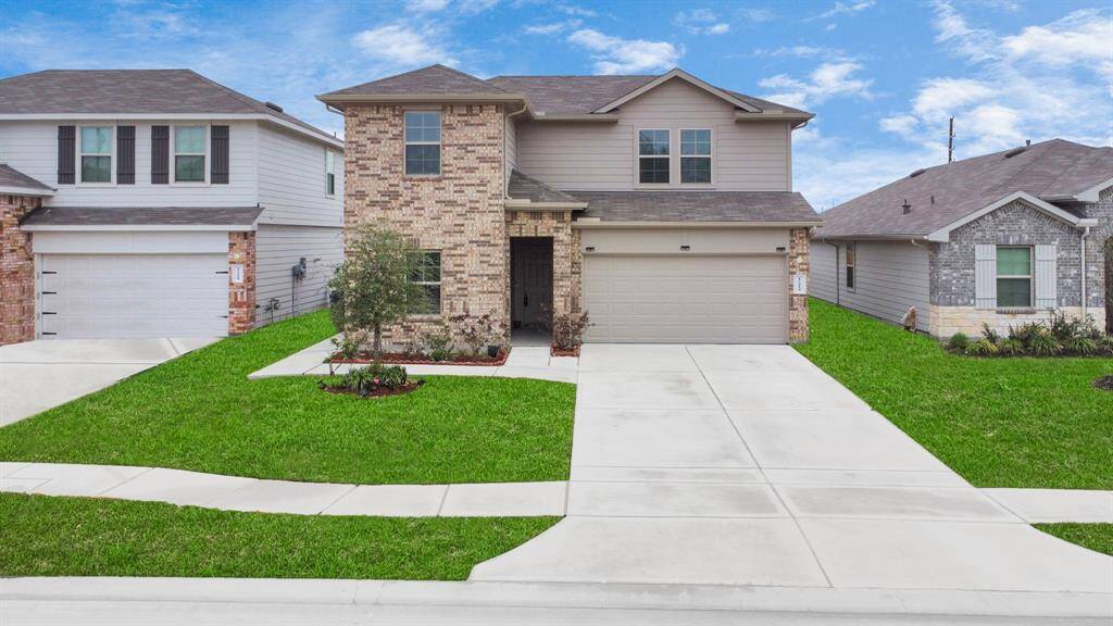 This two-story, modern brick and siding home has a two-car garage. It features a well-maintained lawn and a simple, clean driveway. This home is an owner's pride and very well kept.