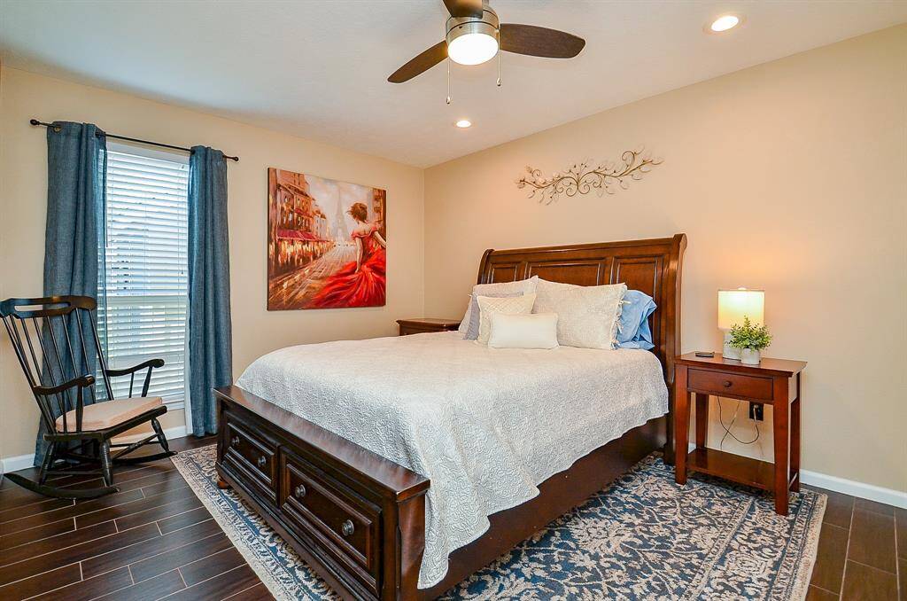 Third bedroom offers room for a king size bed, warm lighting, elegant tile planks and a nice size walk-in closet.