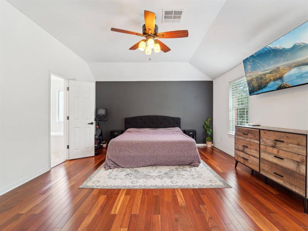 This Primary Bedroom is huge and has pretty wood flooring!