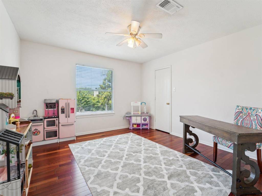 Bedroom 5 is being used as a play room and office area.