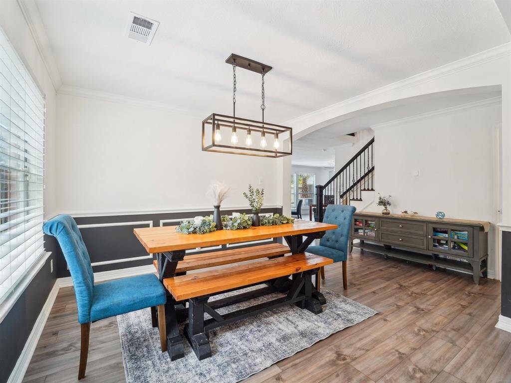 Take a look at that pretty light fixture that crowns the dining table.